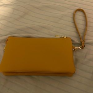 Yellow hand bag with card compartments and three zipper compartments